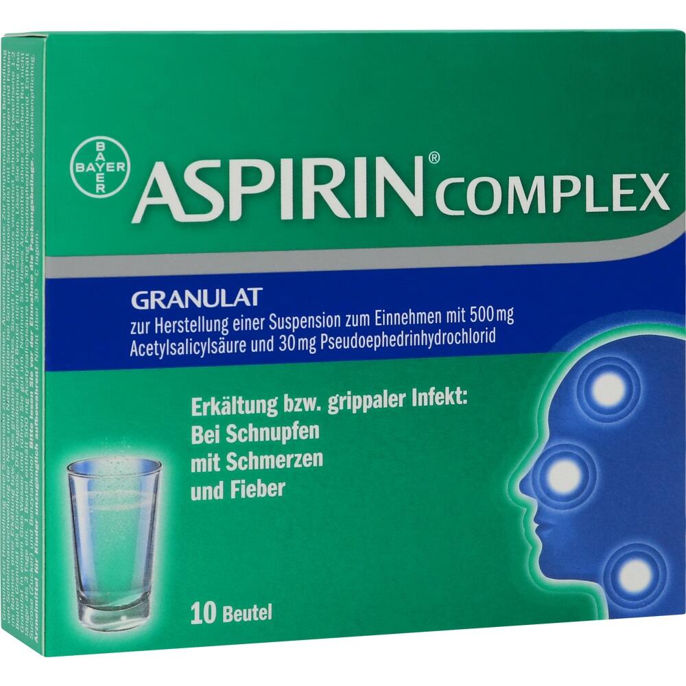 Grüne Packung eines Erkältungsmittels mit einem Glas Wasser darauf.
